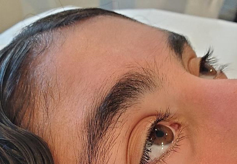 On the table, seen from above — the brow and the lash line